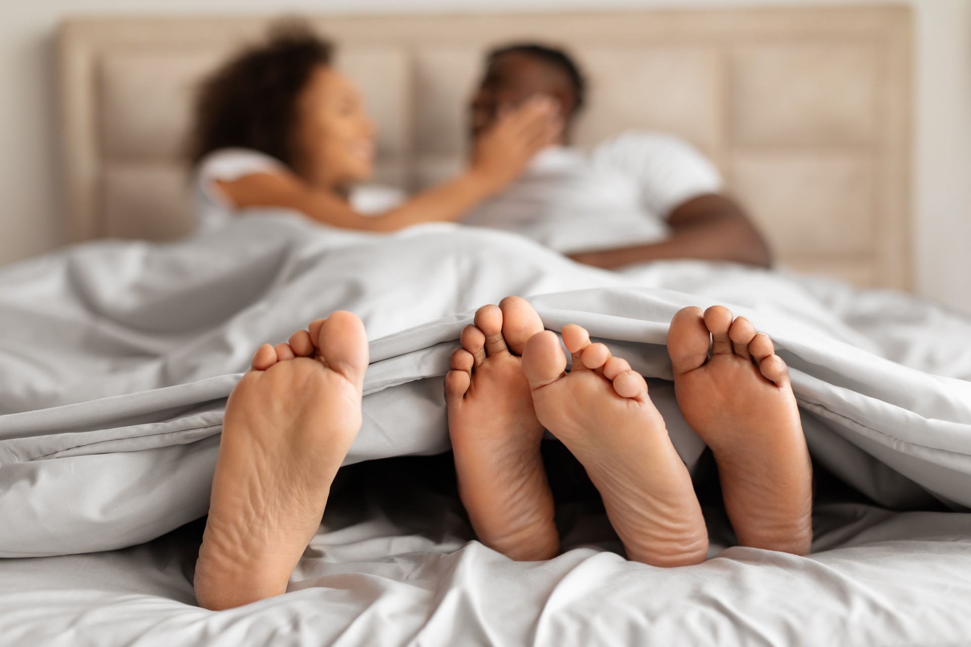 Unrecognizable Young Black Couple Making Love Enjoying Intimacy In Bed